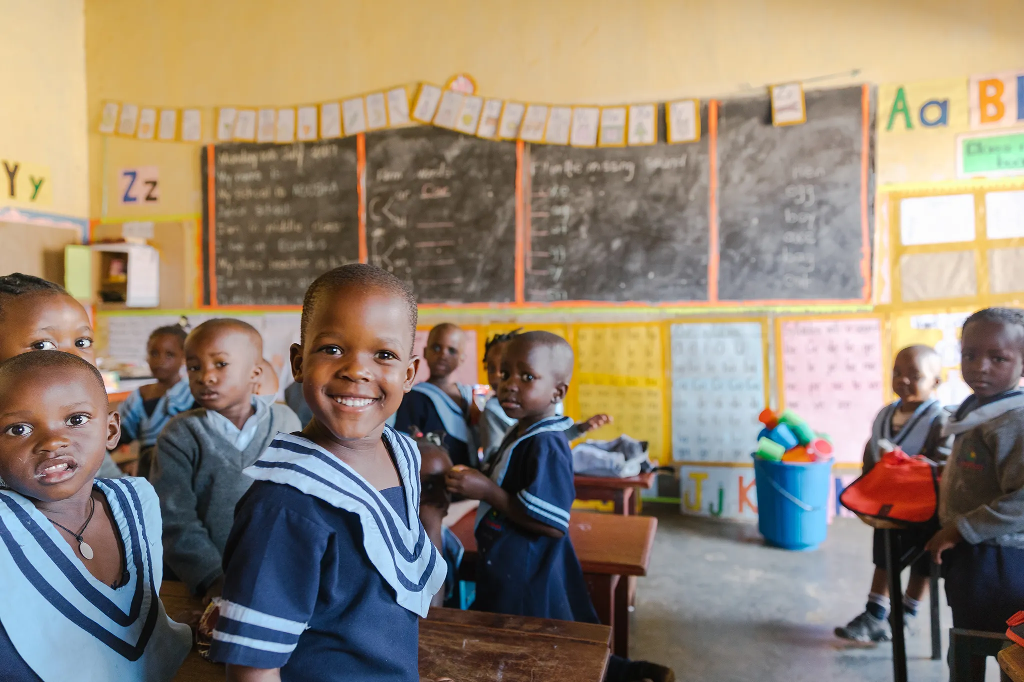 Children in their bright, colorful classroom at the Abusha Day School in Uganda.